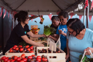 Volunteers handing our produce